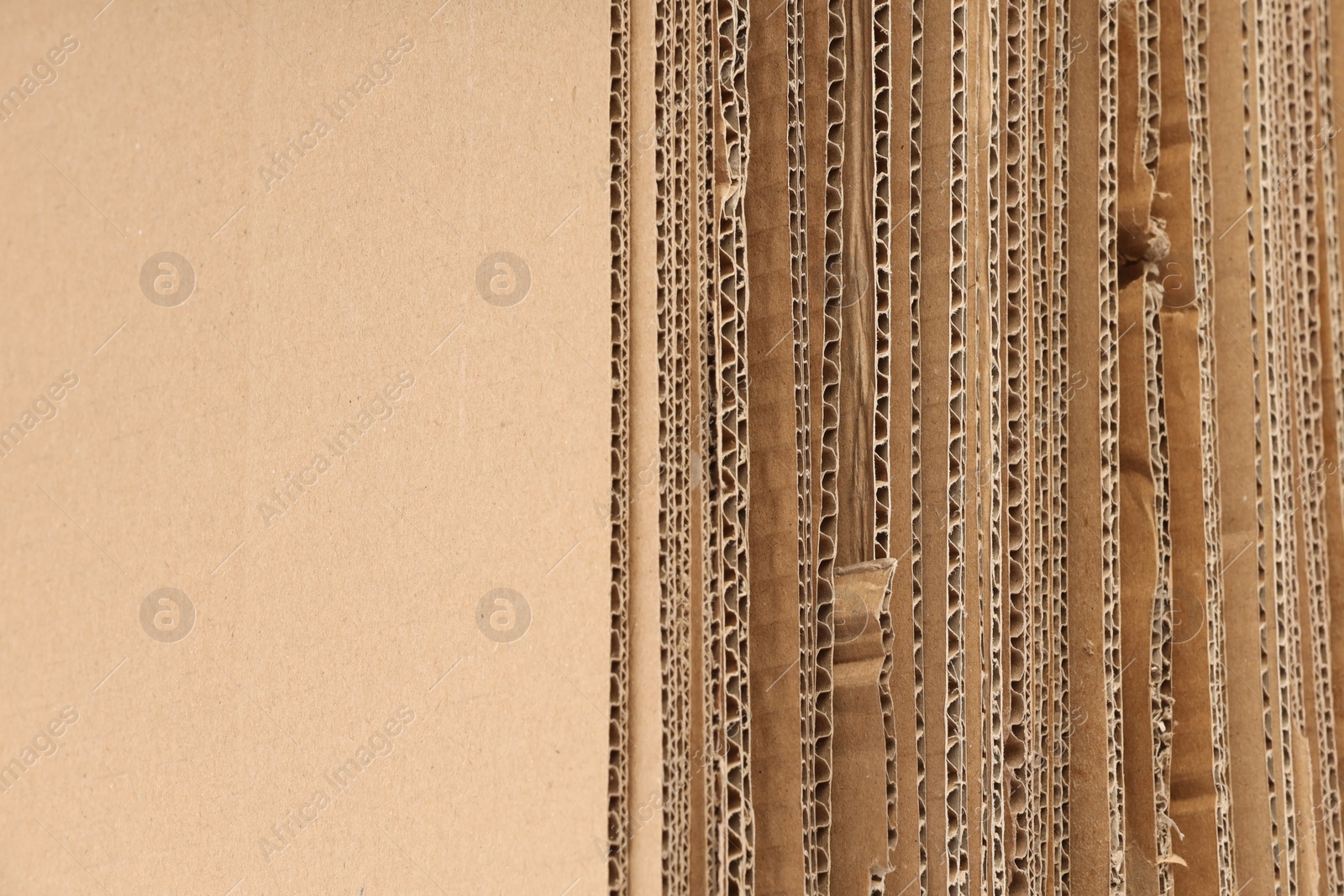 Photo of Sheets of brown corrugated cardboard as background, closeup