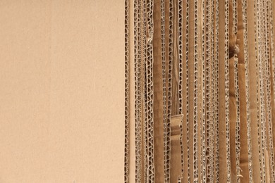 Photo of Sheets of brown corrugated cardboard as background, closeup