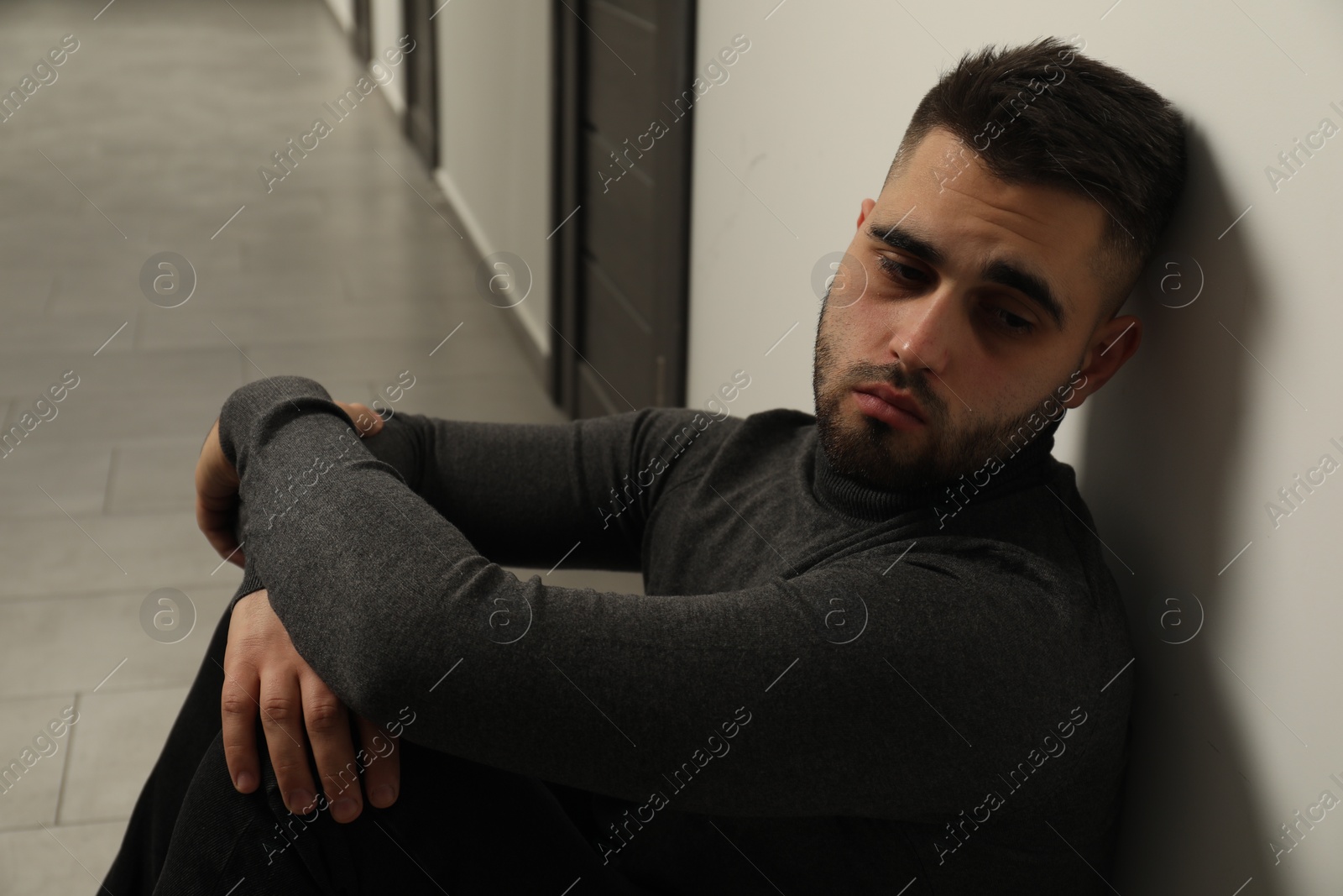 Photo of Portrait of sad young man in hall