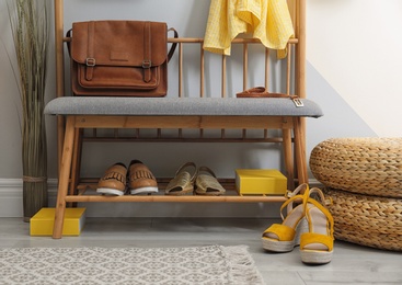 Photo of Stylish hallway interior with storage bench near light wall