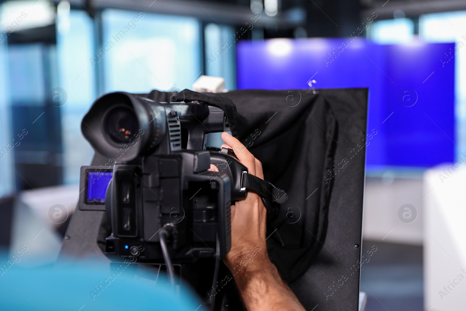 Photo of Professional video camera operator working in studio, closeup