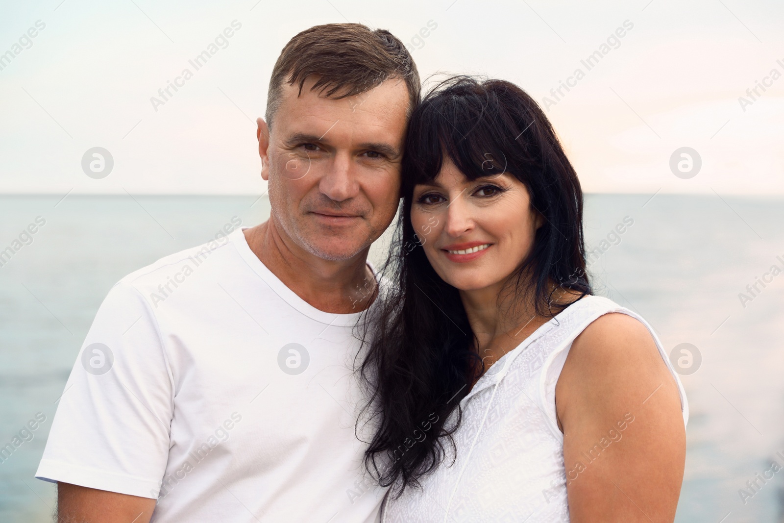 Photo of Happy mature couple spending time together on sea beach