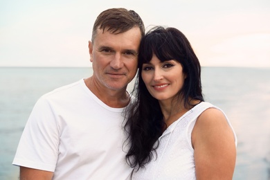 Happy mature couple spending time together on sea beach