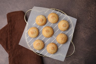 Photo of Tasty sweet sugar cookies on brown table, top view