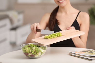 Young woman in fitness clothes preparing healthy breakfast at home, closeup