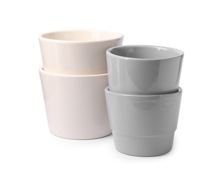 Photo of Different empty ceramic flower pots on white background