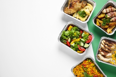 Photo of Lunchboxes on color table, flat lay. Healthy food delivery