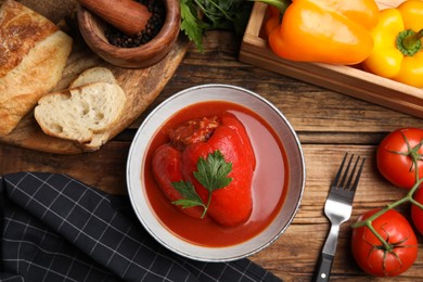 Delicious stuffed pepper served on wooden table, flat lay