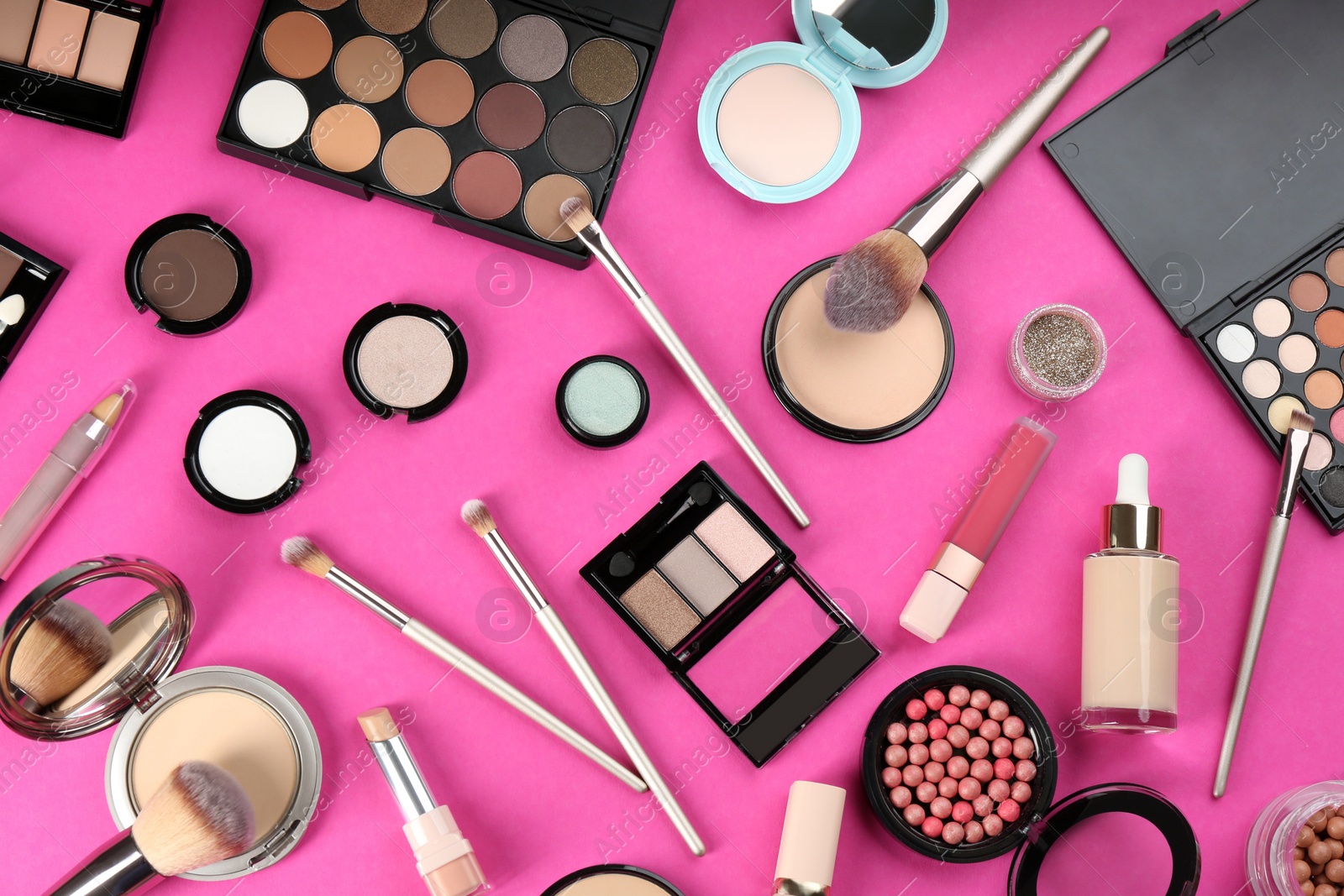 Photo of Flat lay composition with makeup brushes on bright pink background