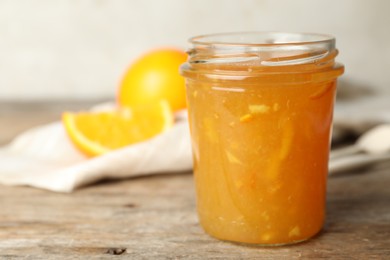 Photo of Homemade delicious orange jam on wooden table