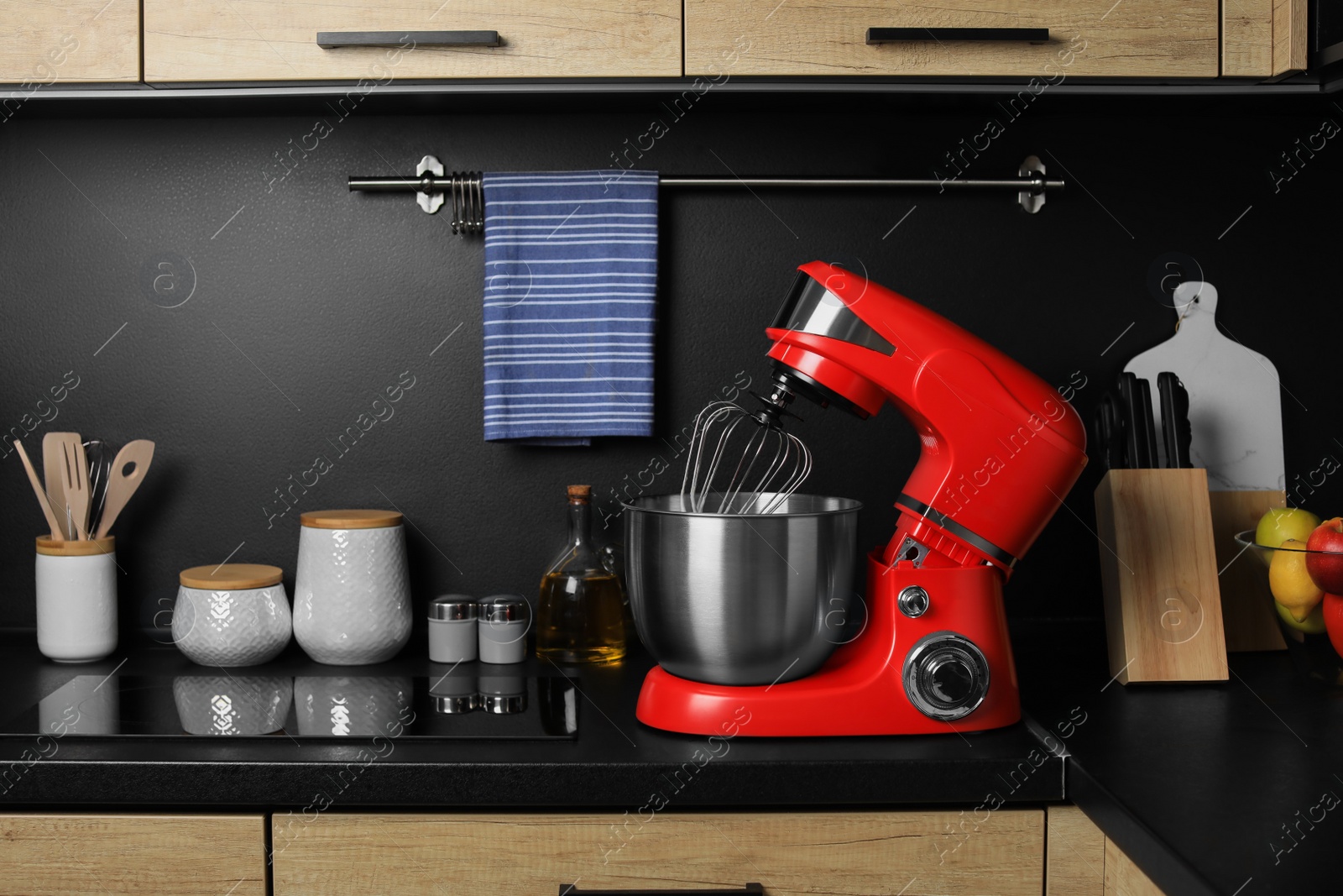 Photo of Modern stand mixer on countertop in kitchen. Home appliance