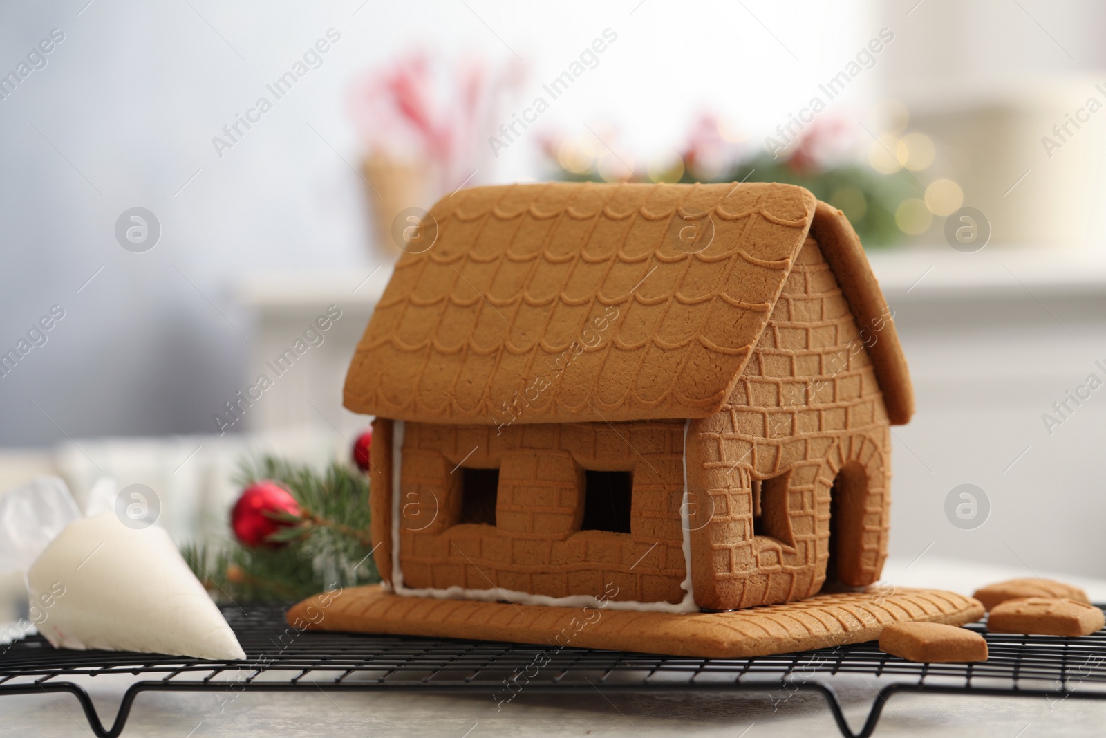 Photo of Gingerbread house on cooling rack, closeup. Christmas treat