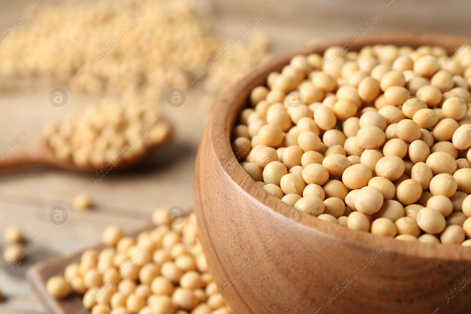 Photo of Natural soy beans on wooden table, closeup. Space for text