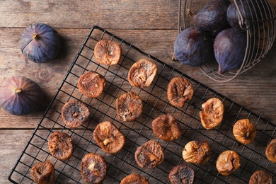 Photo of Flat lay composition with fresh and dried figs on wooden background