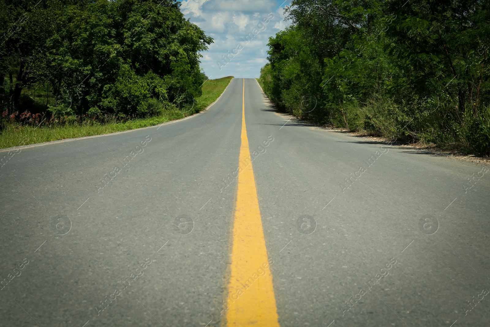 Photo of Picturesque view of empty road near trees