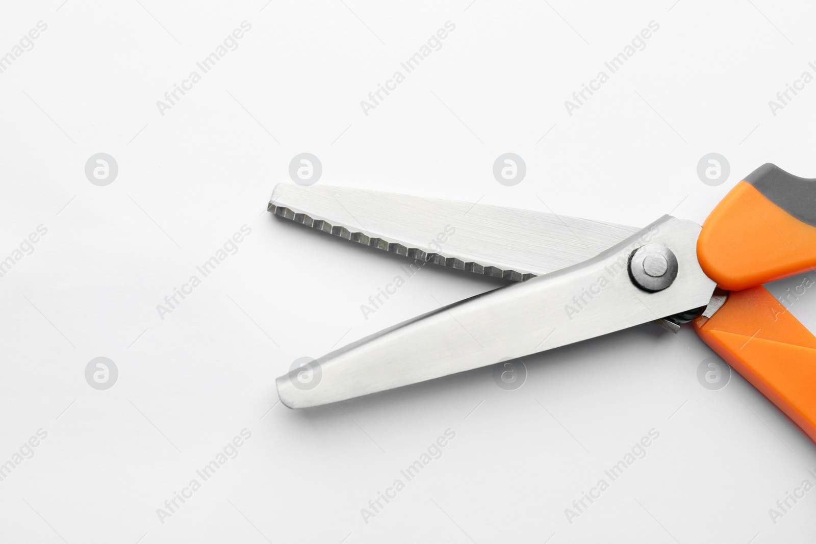 Photo of Pair of sharp scissors on white background