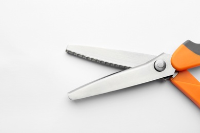 Pair of sharp scissors on white background