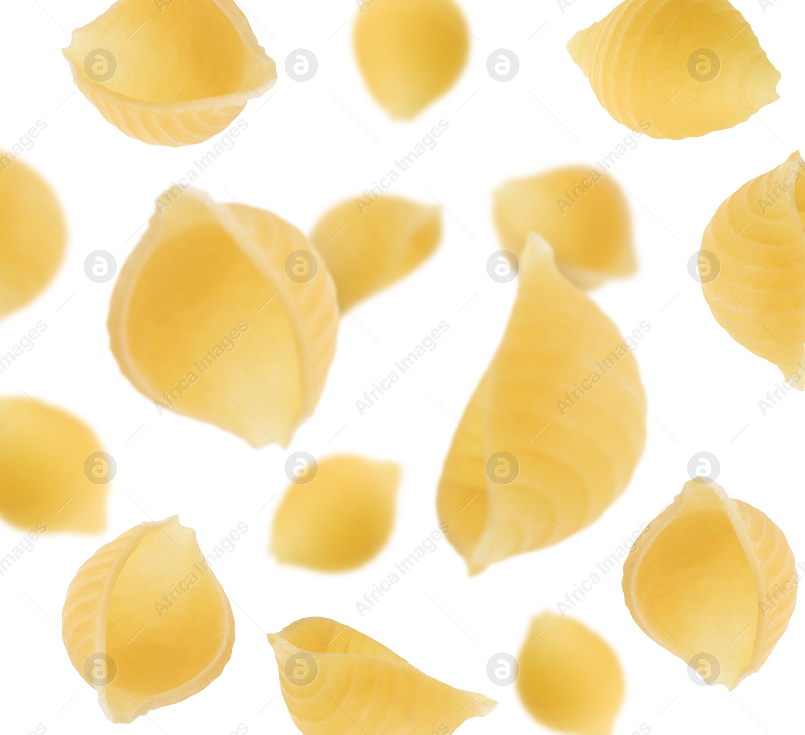 Image of Raw conchiglie pasta flying on white background