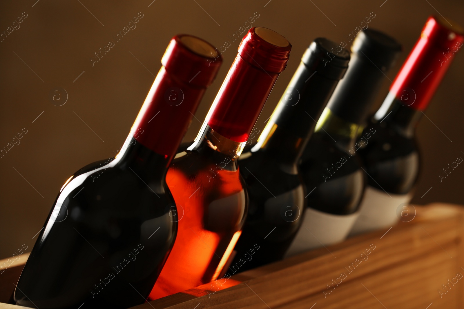 Photo of Bottles of different wines, closeup. Expensive collection