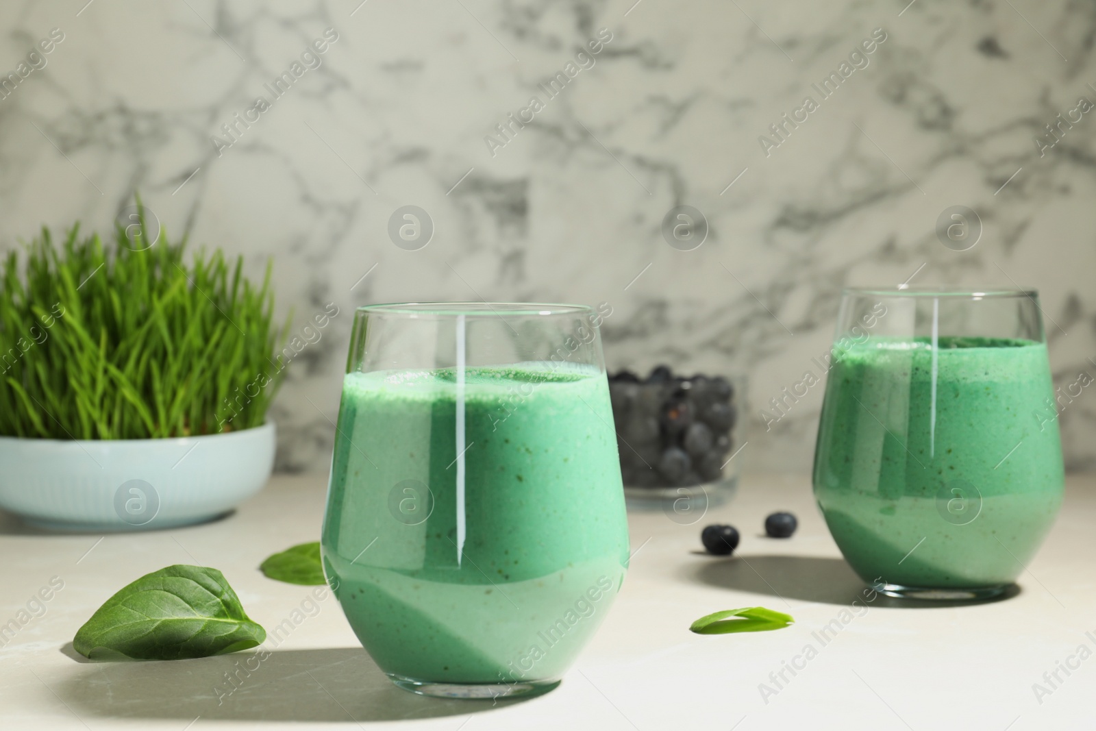 Photo of Glasses of fresh spirulina smoothie on table