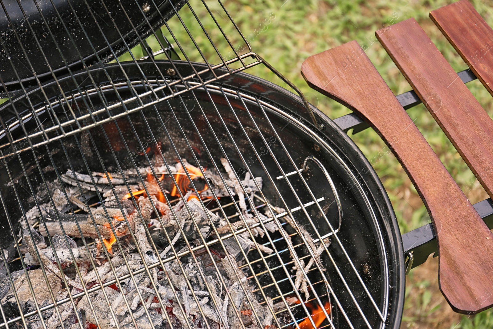 Photo of New modern barbecue grill outdoors, closeup. Summer picnic