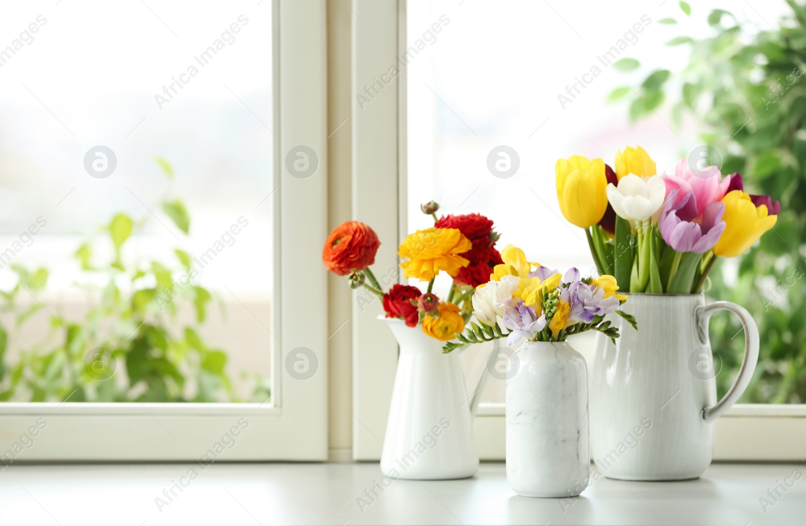 Photo of Different beautiful spring flowers on window sill. Space for text