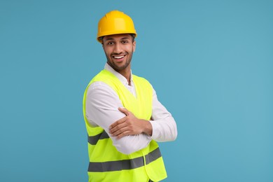 Photo of Engineer in hard hat on light blue background