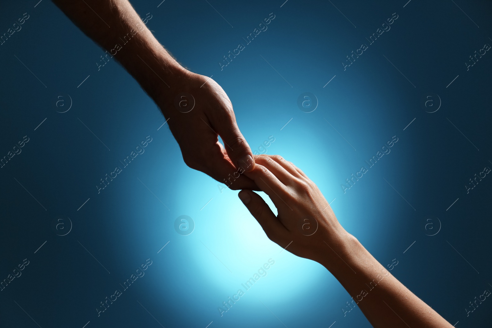 Photo of Man and woman holding hands on color background, closeup. Help and support concept