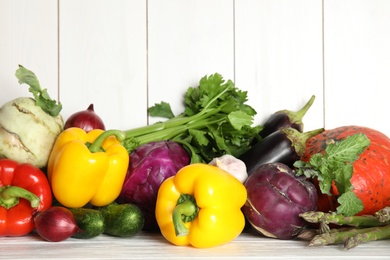 Many fresh ripe vegetables on wooden background. Organic food