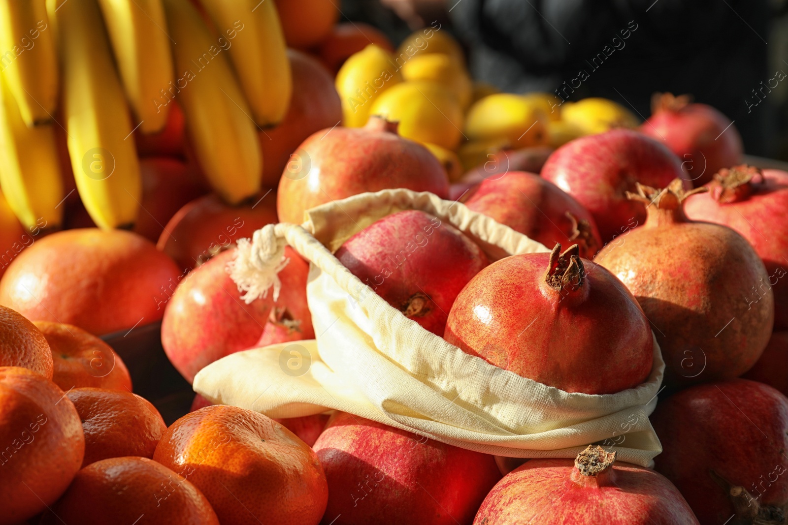 Photo of Cotton eco bag with fruits on pomegranates. Life without plastic