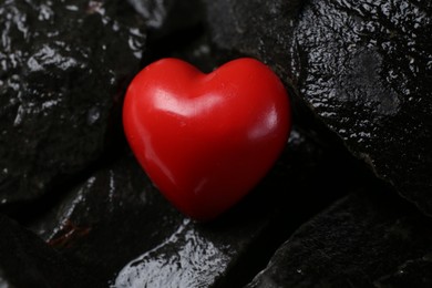 Red decorative heart on stones, closeup view