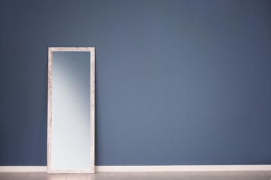 Large stylish mirror in empty room