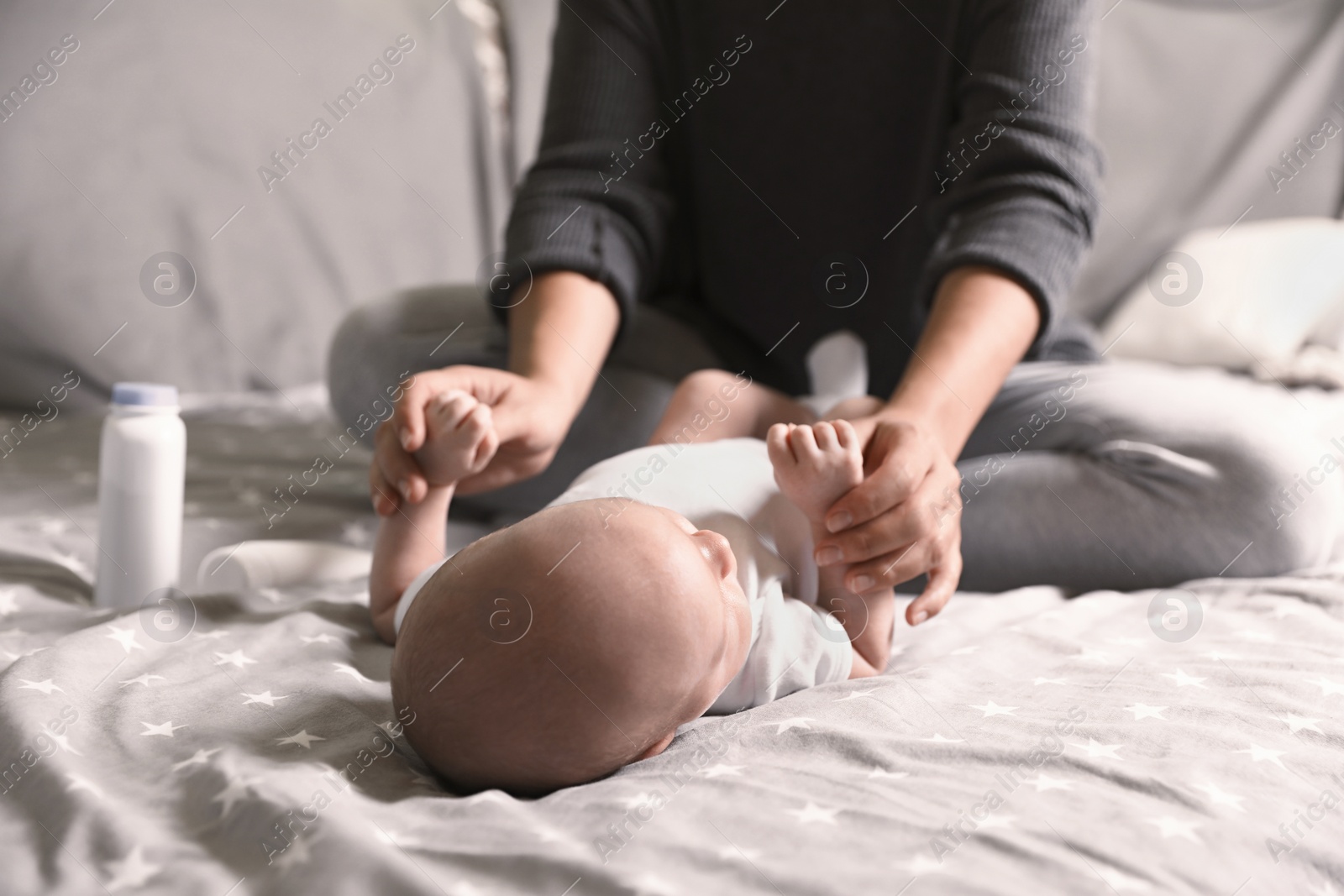 Photo of Mother and her little baby on bed, closeup