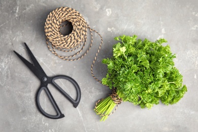 Flat lay composition with fresh green parsley on grey background