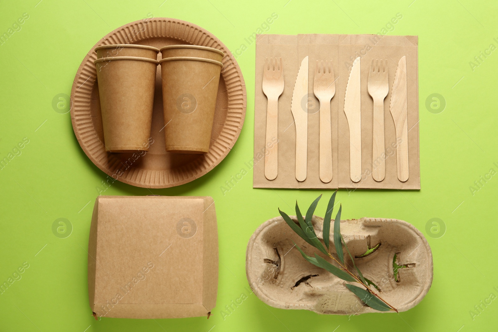 Photo of Flat lay composition with eco friendly products on light green background