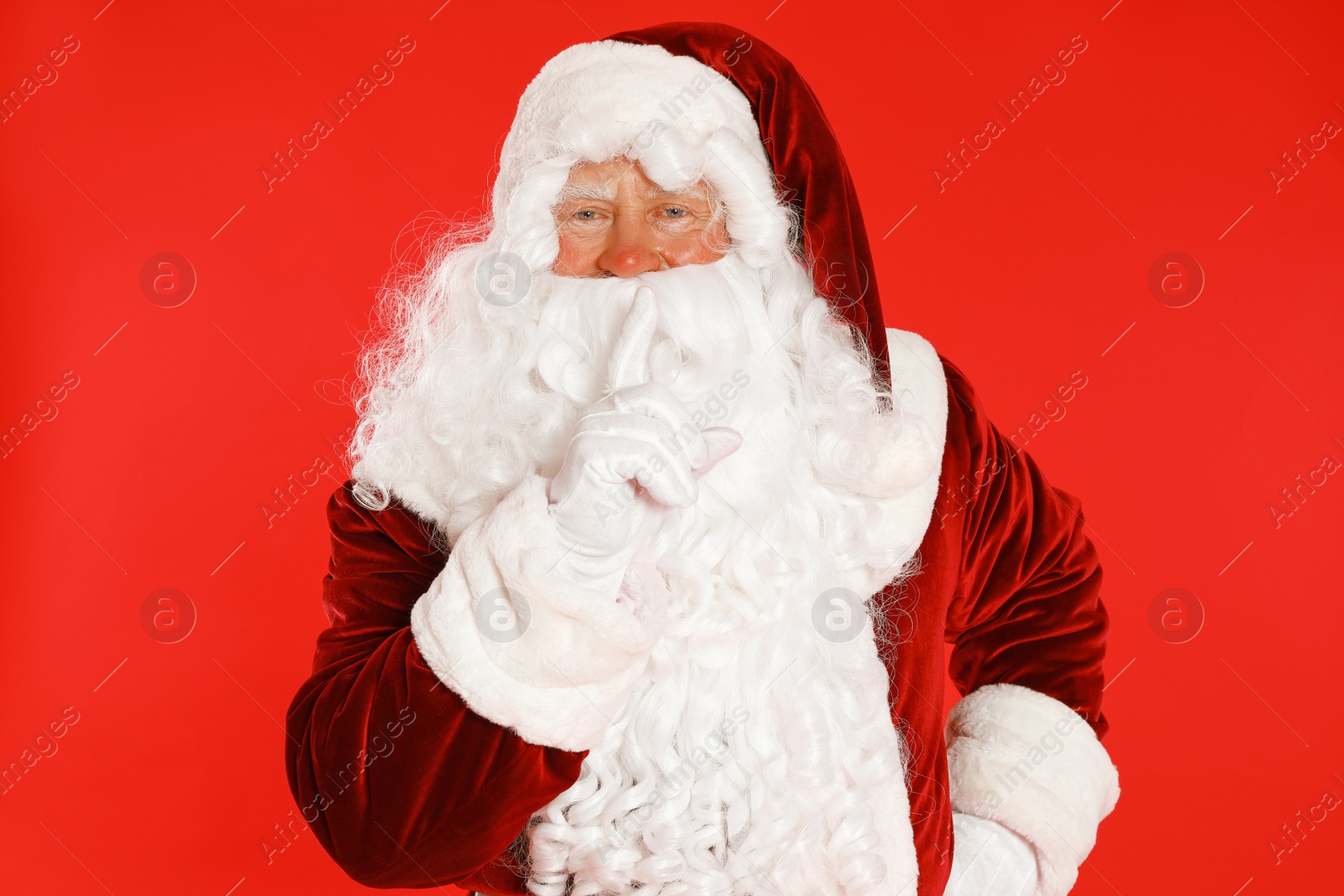 Photo of Happy authentic Santa Claus on red background