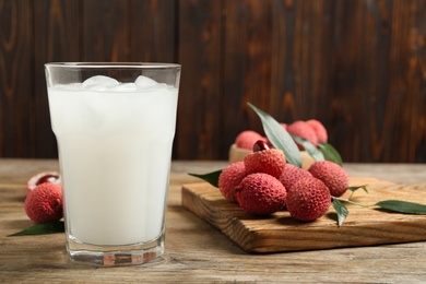 Fresh lychee juice and fruits on wooden table