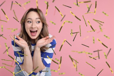 Image of Happy woman and flying confetti on pink background