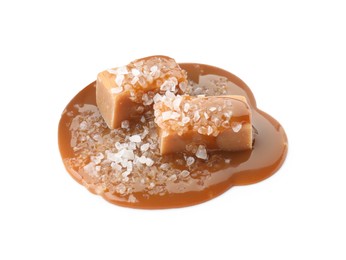 Photo of Yummy candies with caramel sauce and sea salt isolated on white