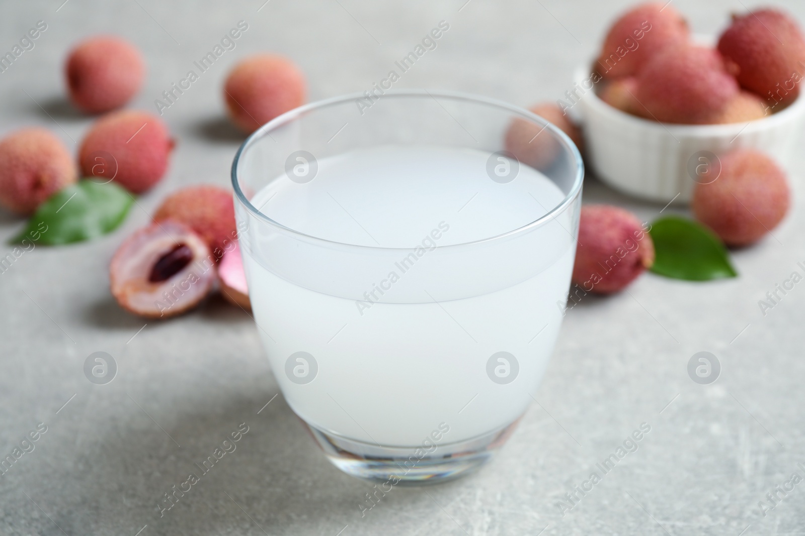 Photo of Freshly made lychee juice on light table, closeup