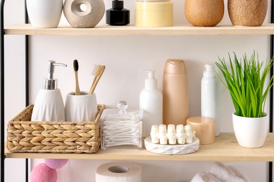 Photo of Different bath accessories, personal care products and artificial plant indoors