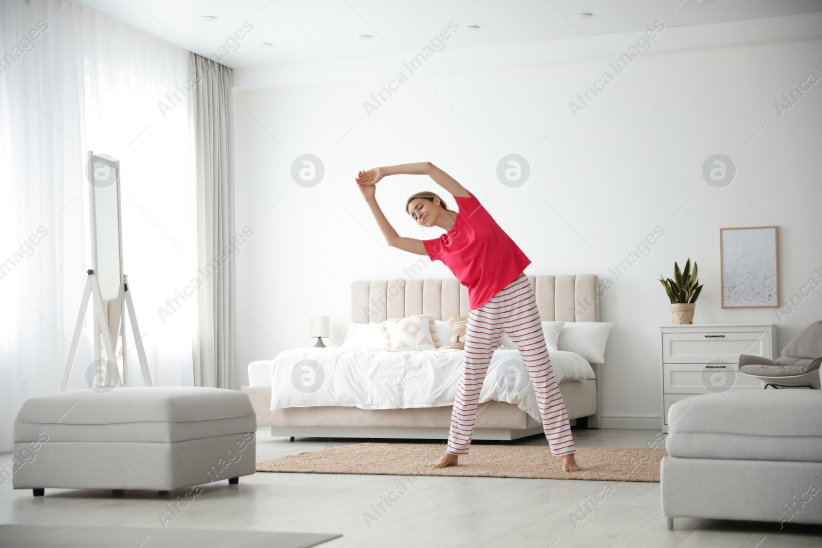 Photo of Young woman doing gymnastics at home. Morning fitness