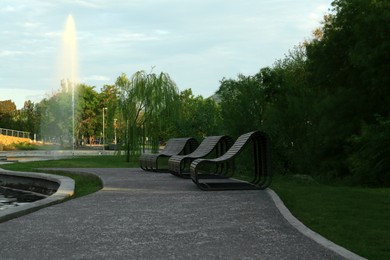 Picturesque view of park with fountain and wooden benches