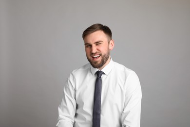 Photo of Portrait of happy businessman on light grey background. Personality concept