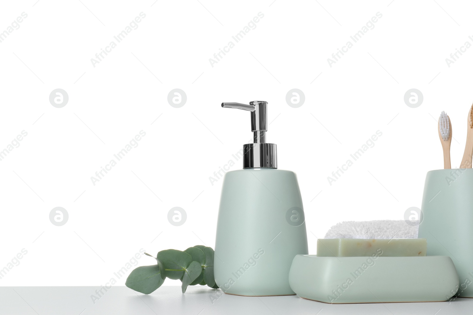 Photo of Bath accessories. Different personal care products and eucalyptus branch on table against white background. Space for text