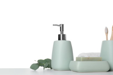 Photo of Bath accessories. Different personal care products and eucalyptus branch on table against white background. Space for text