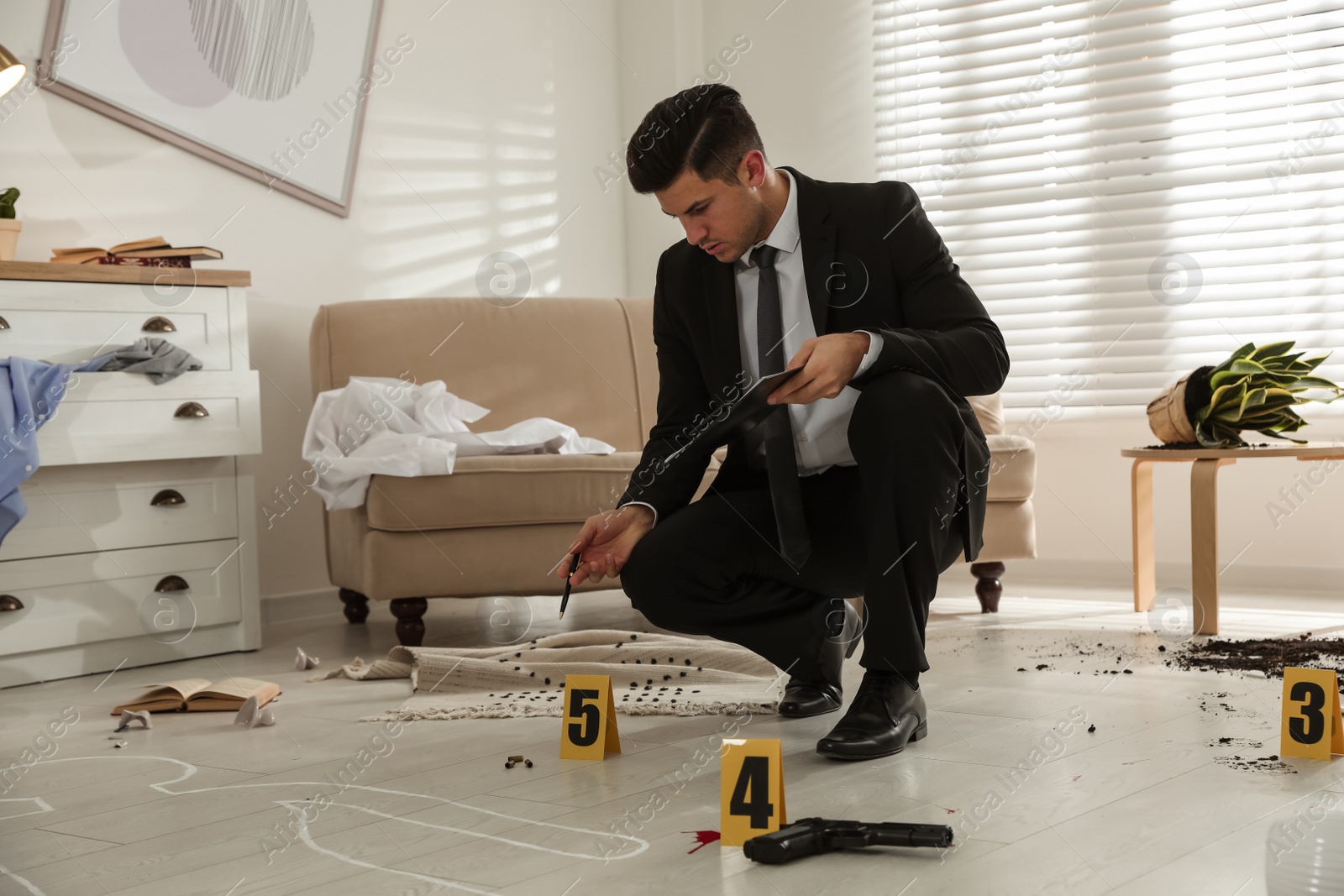 Photo of Investigator in black suit examining crime scene