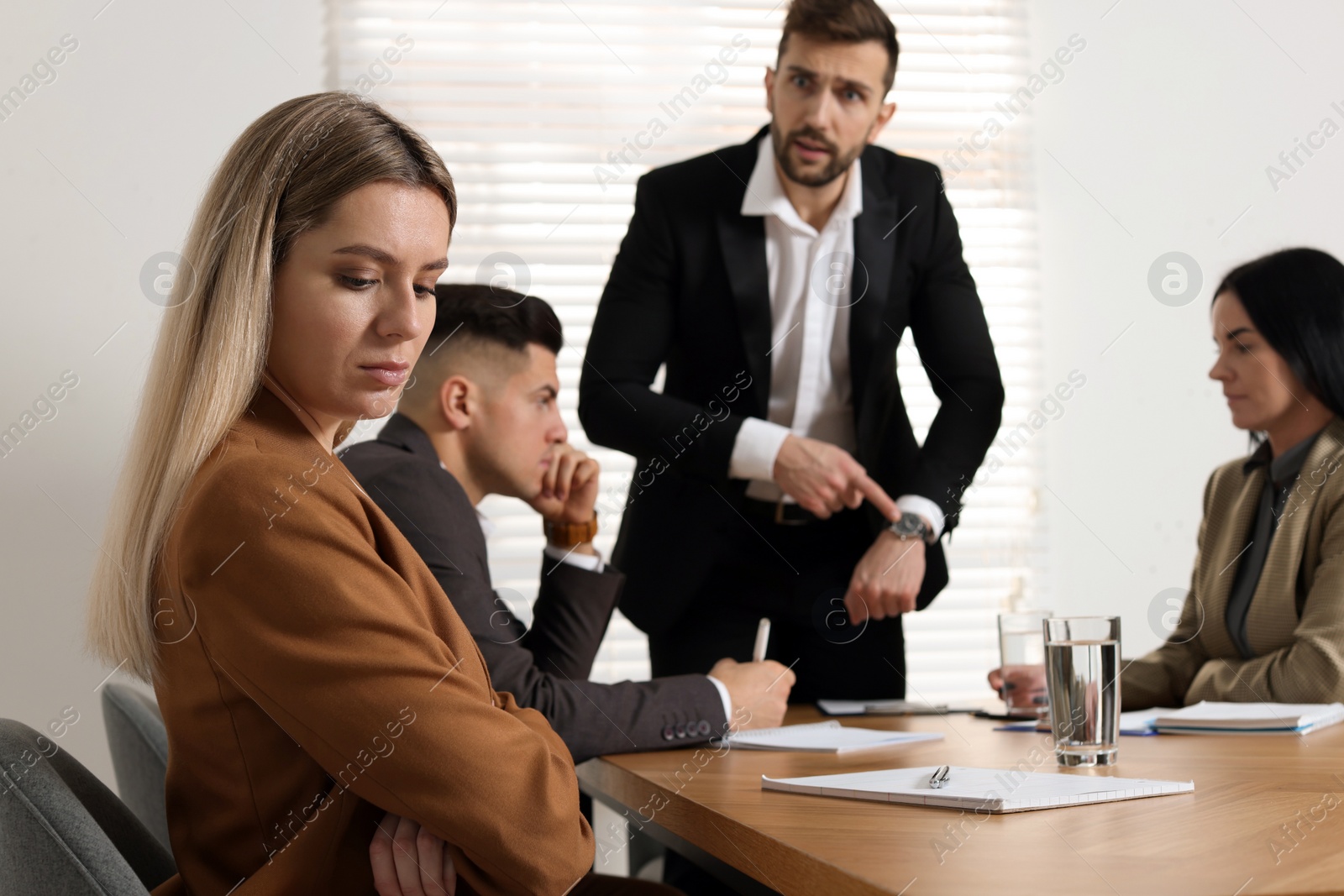 Photo of Businessman scolding employee for being late on meeting in office