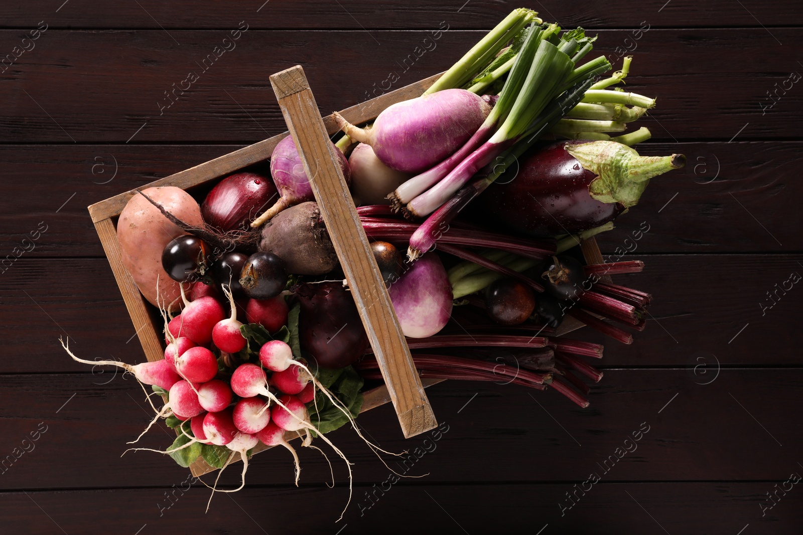 Photo of Different fresh ripe vegetables on wooden table, top view