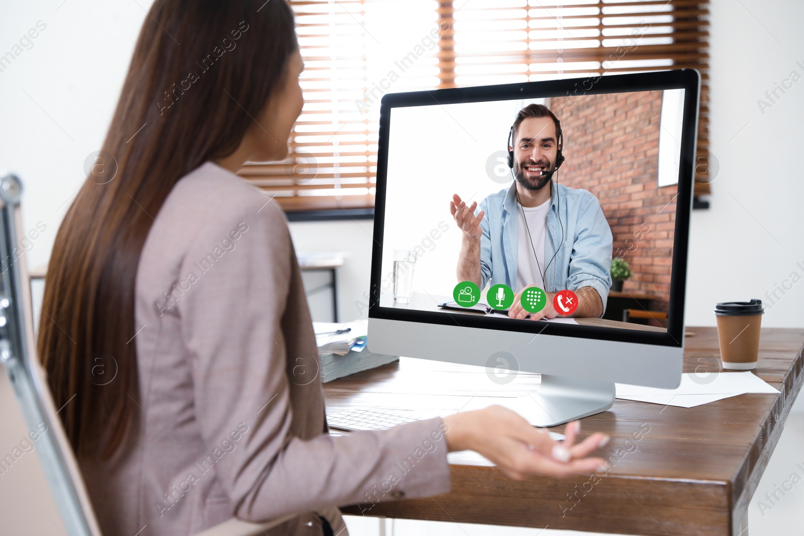 Image of Woman using video chat for online job interview in office